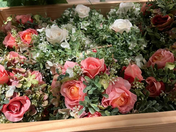 plastic flower decoration in a cute and aesthetic wooden basket. These colorful plastic plants are commonly used to sweeten the room. its shape like a living plant is very pleasing to the eye.