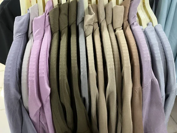 various kinds of shirts hung with a hanger. colorful collared shirts on display in the shop. The texture of the cloth is smooth and comfort to wear. shirt mockup for design. fabric color combination.