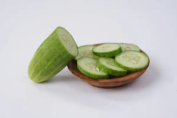 stock image Halves and slices of long cucumber isolated on white background. Green cucumber texture template arranged and harvested. Fresh cucumbers picked from the garden and sold on the shelves in the market.