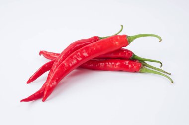 Beyaz arka planda taze kırmızı biber. Dosya kırpma yolları içeriyor. Yakın çekim, kırmızı biber dilimlenmiş, çiğ gıda içeriği kavramı. Kırmızı kırmızı biberler izole edilmiş, seçici odaklanma.