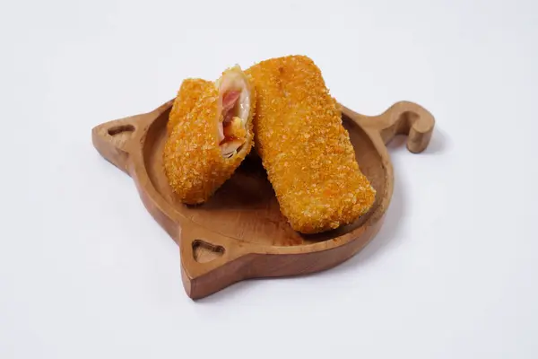 stock image American Risoles or risoles mayo is a traditional Indonesian snack filled with smoked beef or sausage, boiled eggs & mayonnaise. Crispy texture on the outside. Risoles on wood plate isolated white.