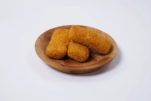 stock image American Risoles or risoles mayo is a traditional Indonesian snack filled with smoked beef or sausage, boiled eggs & mayonnaise. Crispy texture on the outside. Risoles on wood plate isolated white.