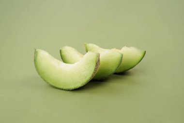 Yeşil kavun, yeşil arka planda izole edilmiş kesik dilim, yeşil kavun.