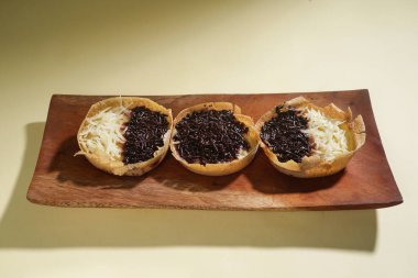 Martabak mini veya terang bulan mini, un, yumurta, maya, peynir veya çikolatayla kaplanmış Endonezya 'nın popüler sokak yemeklerinden biridir. Sarı arka planda izole edilmiş küçük tatlı martabak..