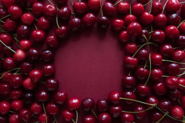 Ripe cherry berries with a space for text in the center. Top view. Food concept. clipart