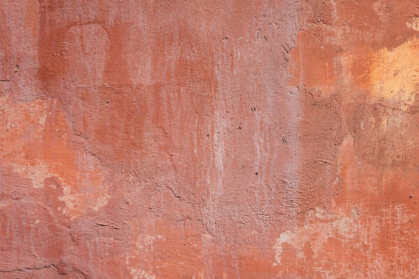 Texture of old cement plaster painted red. Weathered painted wall background texture