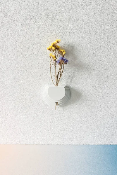 Wall vase for dried flowers.