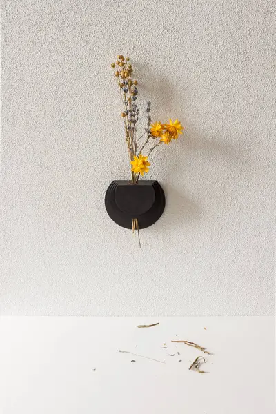 Wall vase for dried flowers.