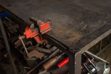 Çalışma masasında küçük bir mengene var.