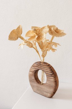 Samandan yapılmış bir buket çiçekli ahşap bir vazo. Samandan örgü