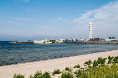 Sea coast with sandy beach and view of Malmo city, Sweden