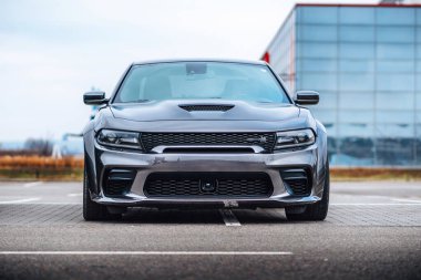 Brno, Çek Cumhuriyeti - 31 Aralık 2023: Otoparka gri bir Dodge Charger park etti. Hızlı lüks spor araba. Amerikan kaslı araba ön görünümü.