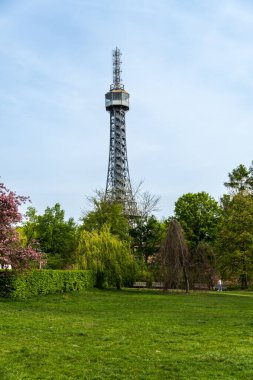 Prague, Czech Republic - April 14, 2023: Petrin observation tower in Prague located in a park among trees on a hill above the city.
