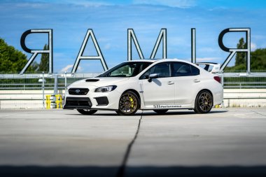 Brno, Czech Republic - May 16, 2024: White Subaru WRX STI sports car. Fast car with all-wheel drive outside in the parking lot.