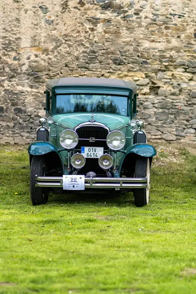 stock image Okor, Czech Republic - 15 April 2023: An old vintage 1930's Buick Coupe is parked outside by a stone wall.