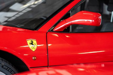 Brno, Çek Cumhuriyeti - 15 Ekim 2024: dikiz aynası ve eski kırmızı lüks arabanın Ferrari logosu. Klasik İtalyan spor arabası..