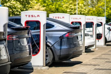 Brno, Çek Cumhuriyeti - 13 Mayıs 2025: Tesla elektrikli arabaları için şarj istasyonu. Bir sürü araba birbirine bağlandı ve pillerini dolduruyor..