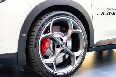 Brno, Çek Cumhuriyeti - 15 Mayıs 2025: Alfa Romeo Junior spor cipinin ön tekerleğinin ayrıntıları. İtalyan elektrikli arabasının kırmızı fren kalibresi..