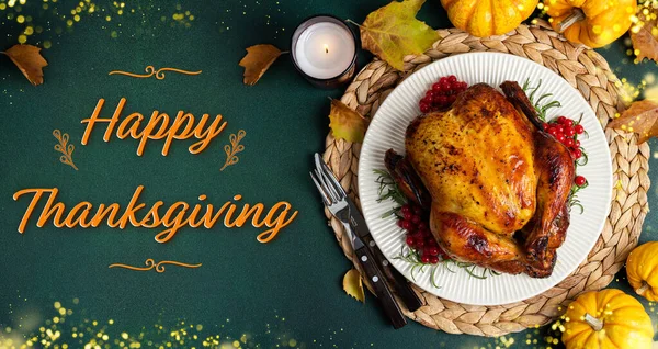 Happy Thanksgiving holiday background. Roasted whole chicken or turkey with autumn vegetables for thanksgiving dinner on dark background. Copy spac