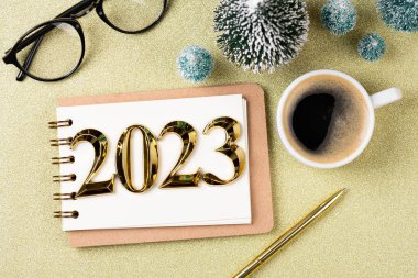 New year resolutions 2023 on desk. 2023 resolutions list with notebook, coffee cup, decorations on table. Goals, resolutions, plan, action concept. New Year 2023 template. Copy spac clipart