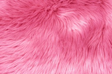 Pink fur texture top view. Pink sheepskin background. Fur pattern. Texture of pink shaggy fur. Wool texture. Sheep fur close up