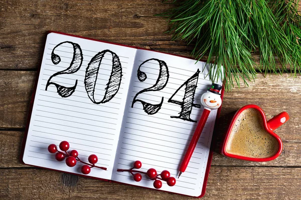 New year resolutions 2024 on desk. 2024 resolutions list with notebook, coffee cup on wooden table. Goals, resolutions, plan, action, checklist concept. New Year 2024 template, copy space