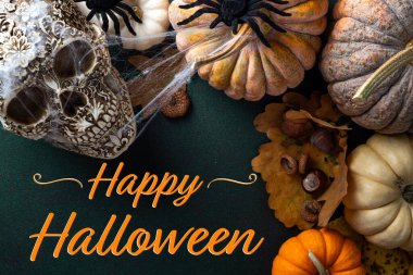 Happy Halloween card. Halloween background with pumpkins, spooky scull, autumn decorations on dark background. Happy Halloween concept clipart