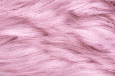 Pink fur texture top view. Pink sheepskin background. Fur pattern. Texture of pink shaggy fur. Wool texture. Sheep fur close up