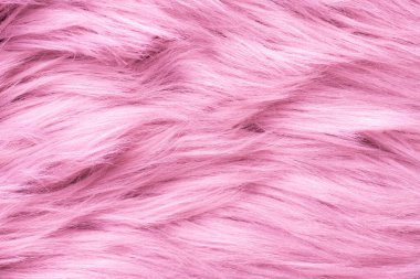 Pembe kürk desenli üst görünüm. Pembe koyun derisi arka plan. Kürk deseni. Pembe tüylü kürk dokusu. Yün dokusu. Koyun kürkü yaklaş.