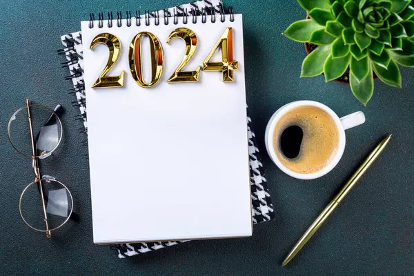 New year resolutions 2024 on desk. 2024 resolutions list with notebook, coffee cup on table. Goals, resolutions, plan, action, checklist concept. New Year 2024 template, copy space