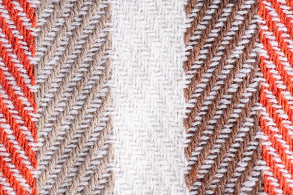 Striped wool knitted plaid or blanket texture, soft and warm, cozy hygge concept. Scottish wool. Fabric for plaid coat and suit. Close up of knitted weave blanket, wool backgroun