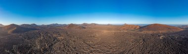 Lanzarote 'deki çorak volkanik Timanfaya Ulusal Parkı üzerindeki panoramik dron görüntüsü