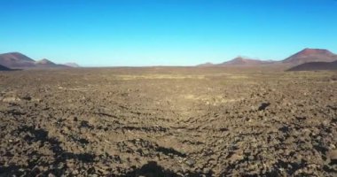 Lanzarote 'deki kısır volkanik Timanfaya Ulusal Parkı' nda güneş doğarken insansız hava aracı videosu.