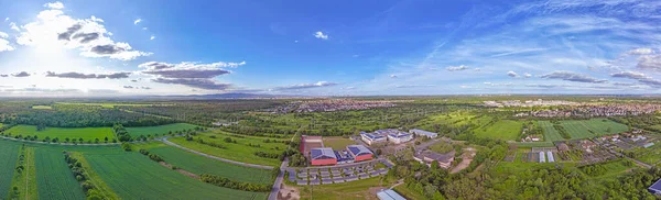 Drone panorama over the outskirts of Frankfurt with the city of Moerfelden-Walldorf and the airport during the day in springtime