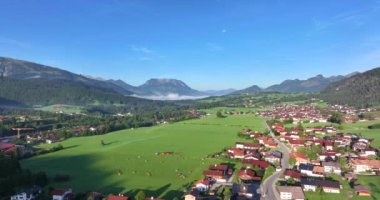 Drone flight over the German alpine village of Reit im Winkl in the morning in summer