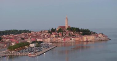 Drone video of the historic Croatian coastal town of Rovinj during sunrise in summer
