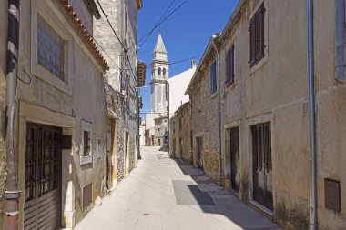 Hırvatistan 'ın tarihi Voznjan kentinden sabah vakti kaldırımlı sokaklar ve eski binalarla tipik bir sokak manzarası