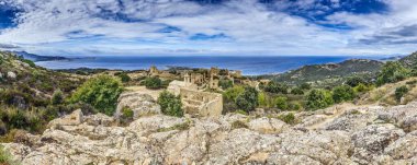 Panoramic view of the ruins in the abandoned historic village of Occi in western Corsica in summer clipart