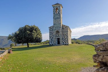 Historic San Michele de Murato church in Corsica, featuring unique architecture and scenic countryside views during daytime clipart