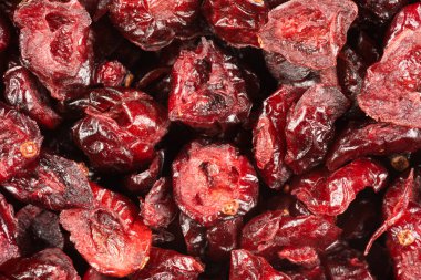 Evenly scattered dried cranberries. Whole and cut fruit visible. 