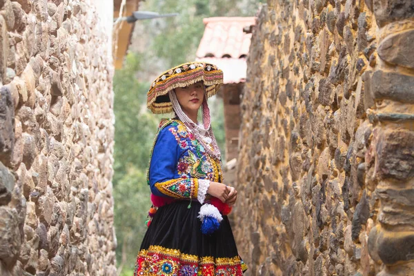 stock image Beautiful girl with traditional dress from Peruvian Andes culture. Young girl in Ollantaytambo city in Incas Sacred Valley in Cusco Peru.