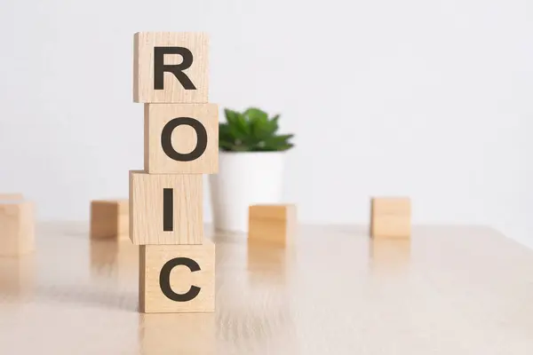 word ROIC with wood cubes, white background