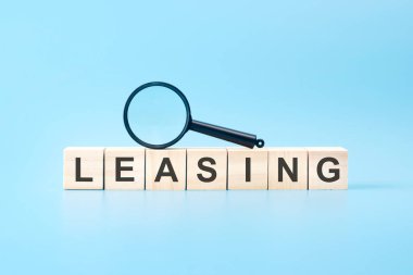 Büyüteçli ahşap bloklar: azaltılıyor. mavi arkaplan