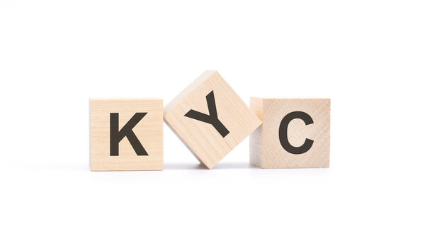 word kyc made with wood building blocks, white background.