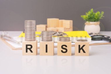 RİSK 'i heceleyen tahta blokların görüntüsüyle aktarılan konsept, maddi risk yönetimi ve yatırım değerlendirmesini sembolize etmektedir.