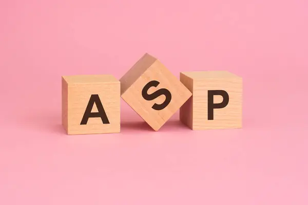 ASP - Average Selling Price symbol. concept word on wooden cubes. beautiful pink background.