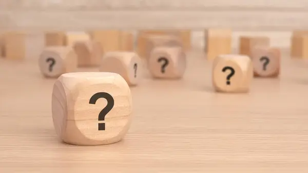 stock image wooden cubes with a question mark engraved on them, front view, closeup