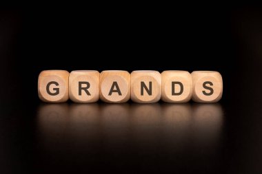 El yapımı ahşap bloklardan oluşan bir koleksiyon. Parlak, siyah bir arka planda büyük babaların harflerini sergiliyorlar.