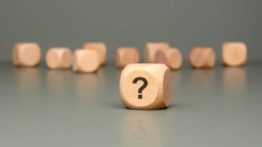 Tahta bloklar, merak, belirsizlik ve soruşturmanın özünü sembolize eden bir soru işaretiyle sıralanmış.