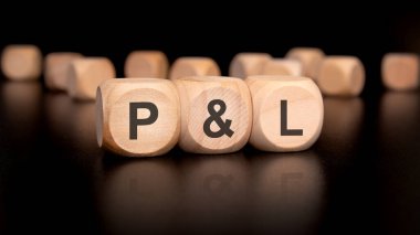 PL harfini heceleyen renkli tahta bloklar, kar ve zarar kavramlarını sembolize ediyor